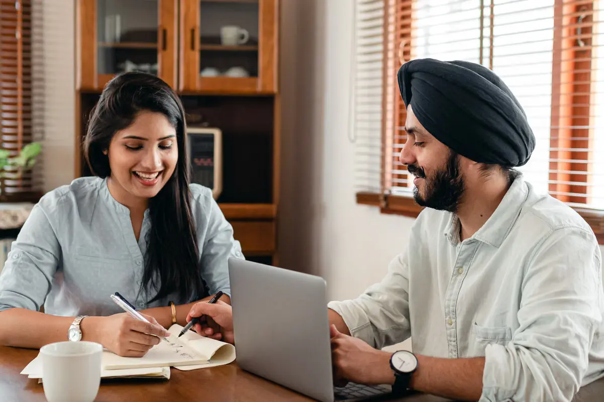 Couple tracking their spousal sponsorship application timeline at home — GS Arora Law
